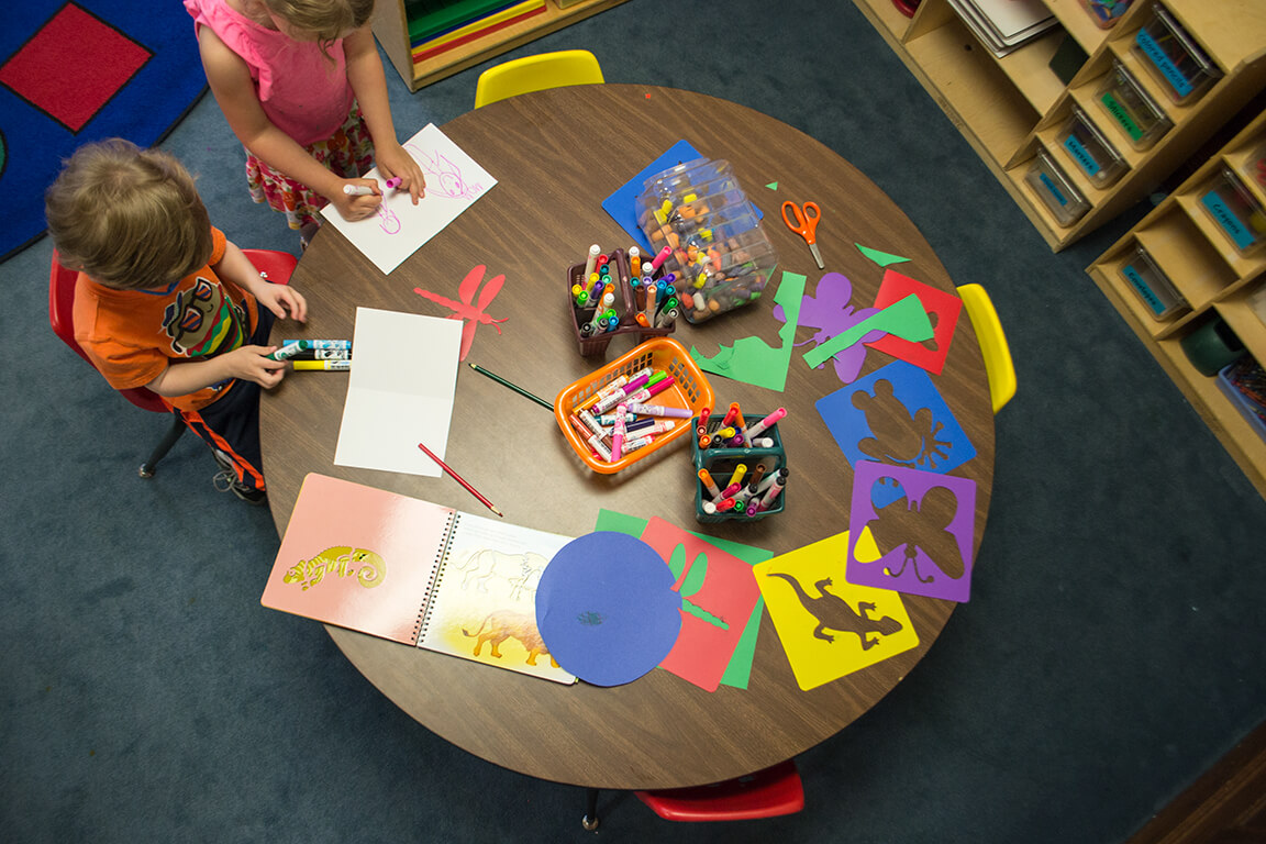 A class work table at Kirk Preschool with art projects